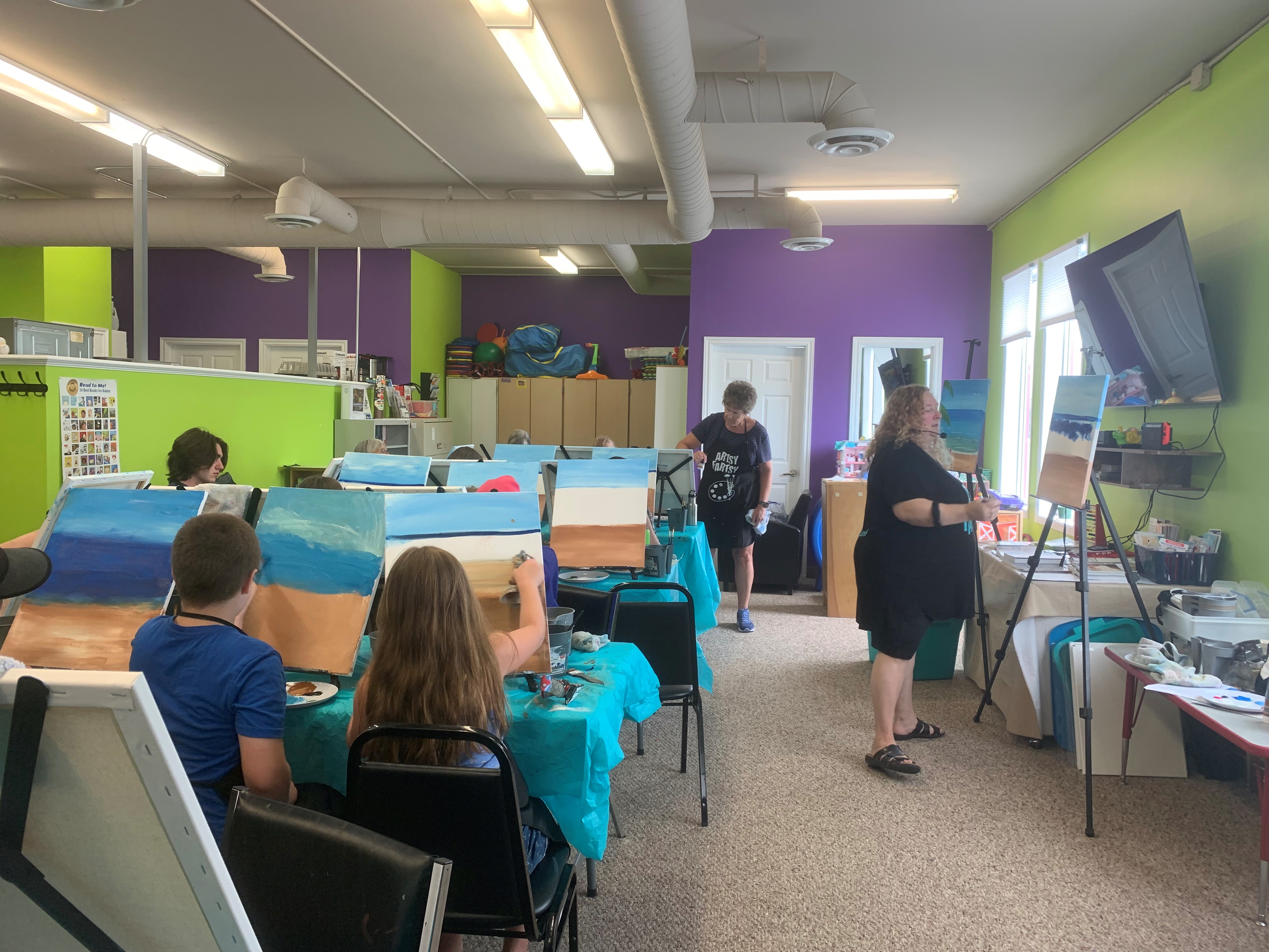 Photo of a group of people taking a paint class