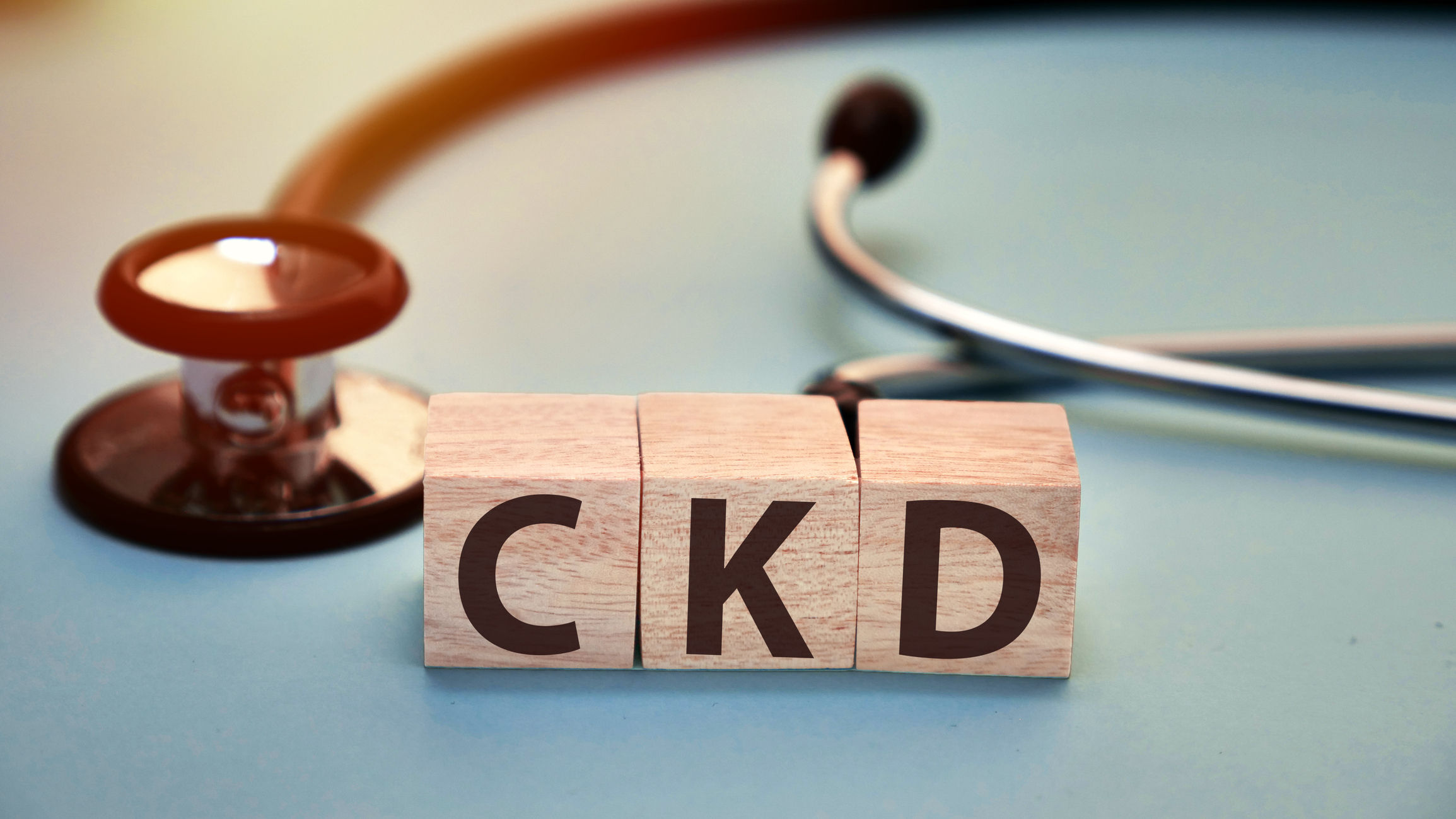 Three wooden blocks spell CKD