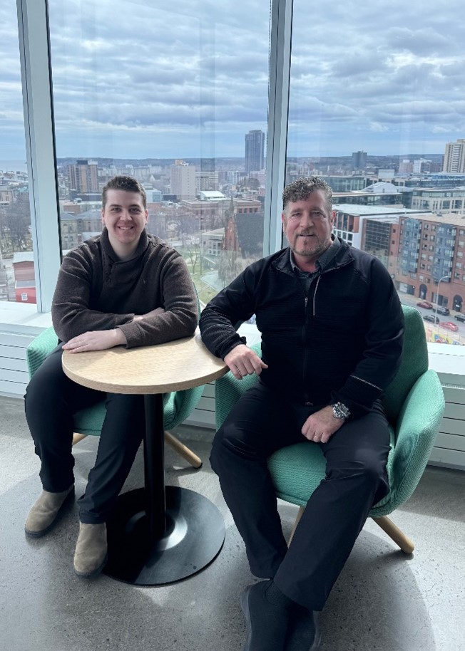 Lachlan McPhee and his dad Darren sit in the Health Innovation Hub