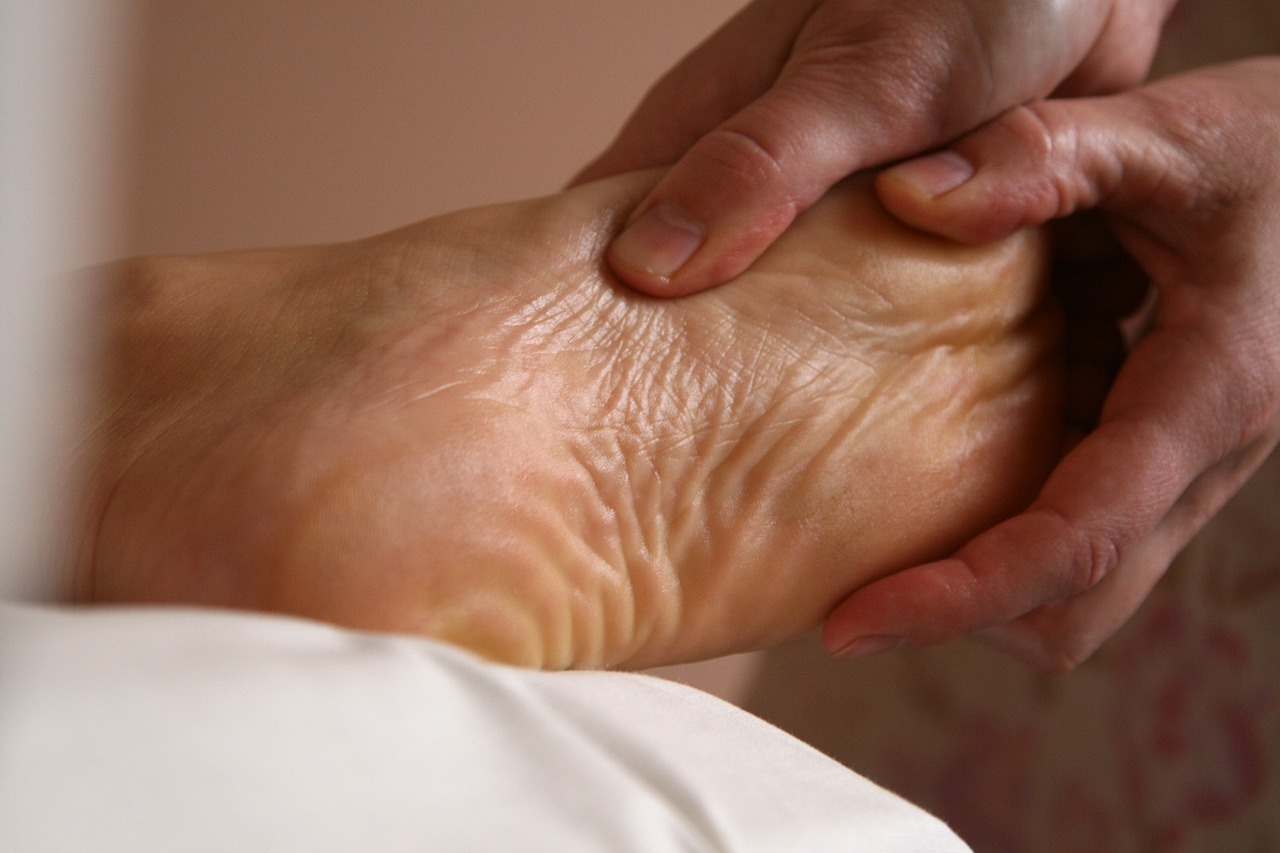 Hands massage a foot.