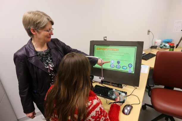 Dr. Gail Eskes works with a student. 
