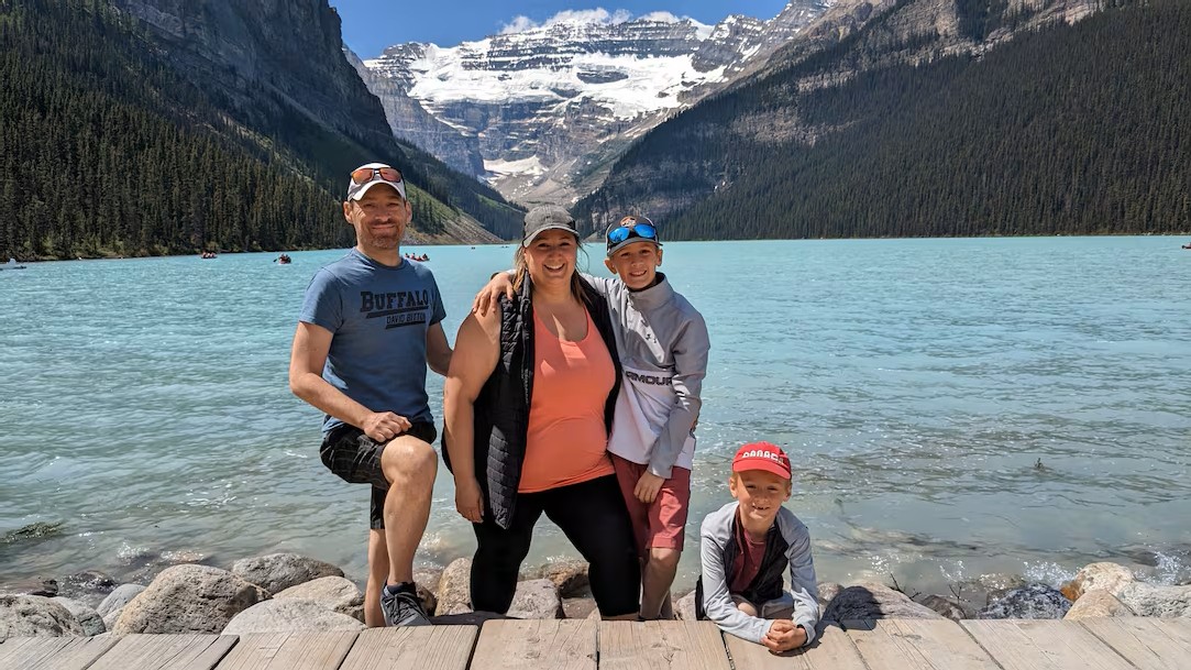 A photo of patient Ryan Deveau and his family at a lake.
