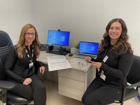 Alexandra Szeto (left) and Cheryl Barrie (right) smile for a photo in their office at the Cape Breton Regional Hospital.