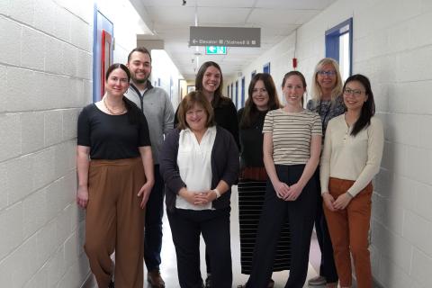 Nurses on the Hematology Research Team smile in a photo taken in the hallway of the Centre for Clinical Research.