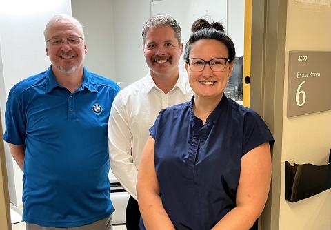 Clinical nurse specialist smiles with Paul Gratzer and Sean Margueratt of DeCell Technologies at the at the Multi-Disciplinary Leg Ulcer Clinic.
