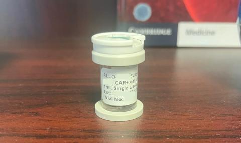 A small vial which previously contained donated genetically engineered CAR T-cells sits on an office shelf. 