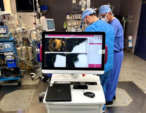 A computer screen on the ROSA ONE surgical robot shows a map for inserting electrodes into a patient's brain.