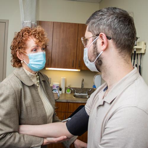 Nurse Practitioner Sue Battersby-Campbell attending a patient at the Walk-In Clinic+ Mill Cove (Bedford) location.