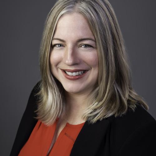 Headshot of Dr. Jennifer Jones, wearing a red shirt and black blazer