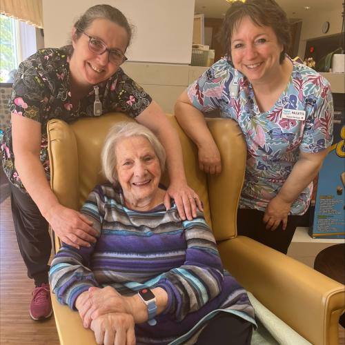 Photo of Tideview staff with resident wearing the Tenera Care technology on their wrist.