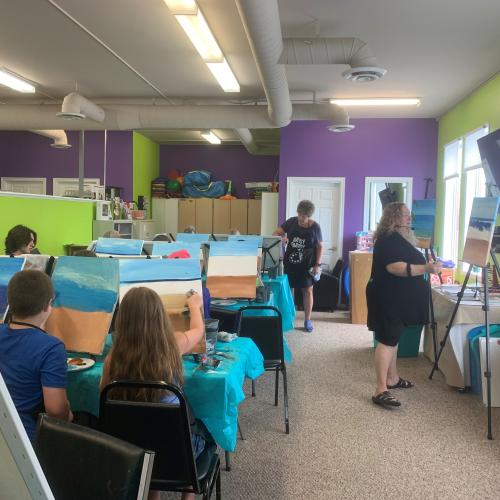 Photo of a group of people taking a paint class