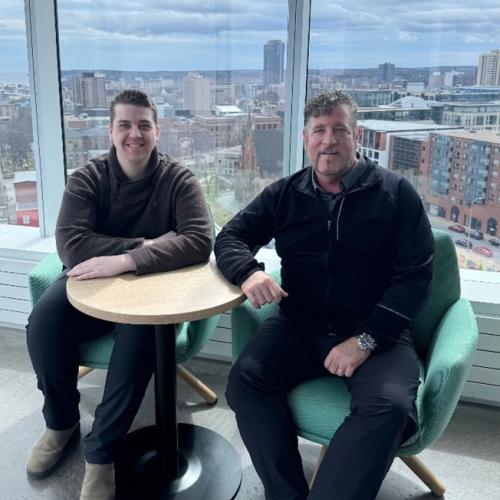 Lachlan McPhee and his dad Darren sit in the Health Innovation Hub