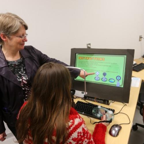 Dr. Gail Eskes works with a student. 